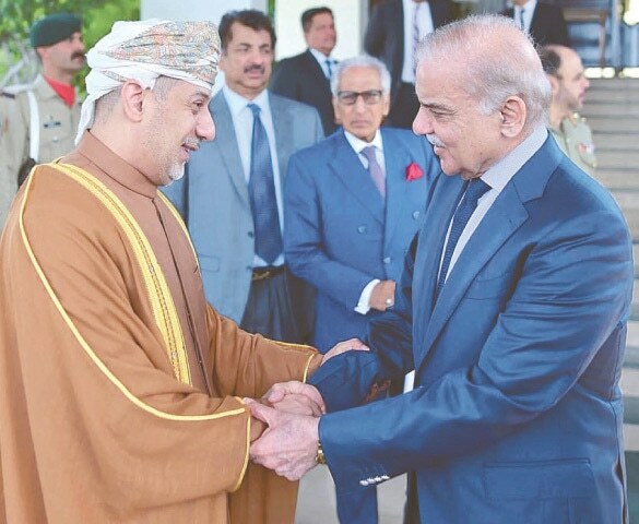 Omani Ambassador Fahad Sulaiman Khalaf Al Kharusi shakes hands with PM Shehbaz Sharif.—APP