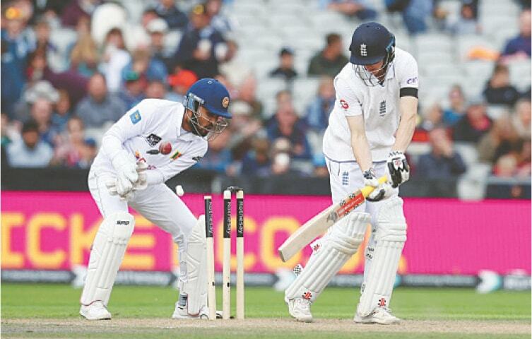 ENGLAND batter Harry Brook is cleaned up by Sri Lankan spinner Prabath Jayasuria as wicket-keeper Dinesh Chandimal reacts during the first Test at Old Trafford on Thursday.—Reuters